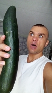 A man with a giant cucumber